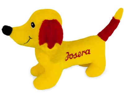 Gelbes Stoffhund-Spielzeug mit roten Ohren, rotem Schwanzende, schwarzer Nase und Josera-Schriftzug auf der Seite.